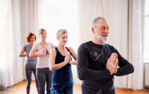 124676438 Group Of Senior People Doing Exercise In Community Center Club